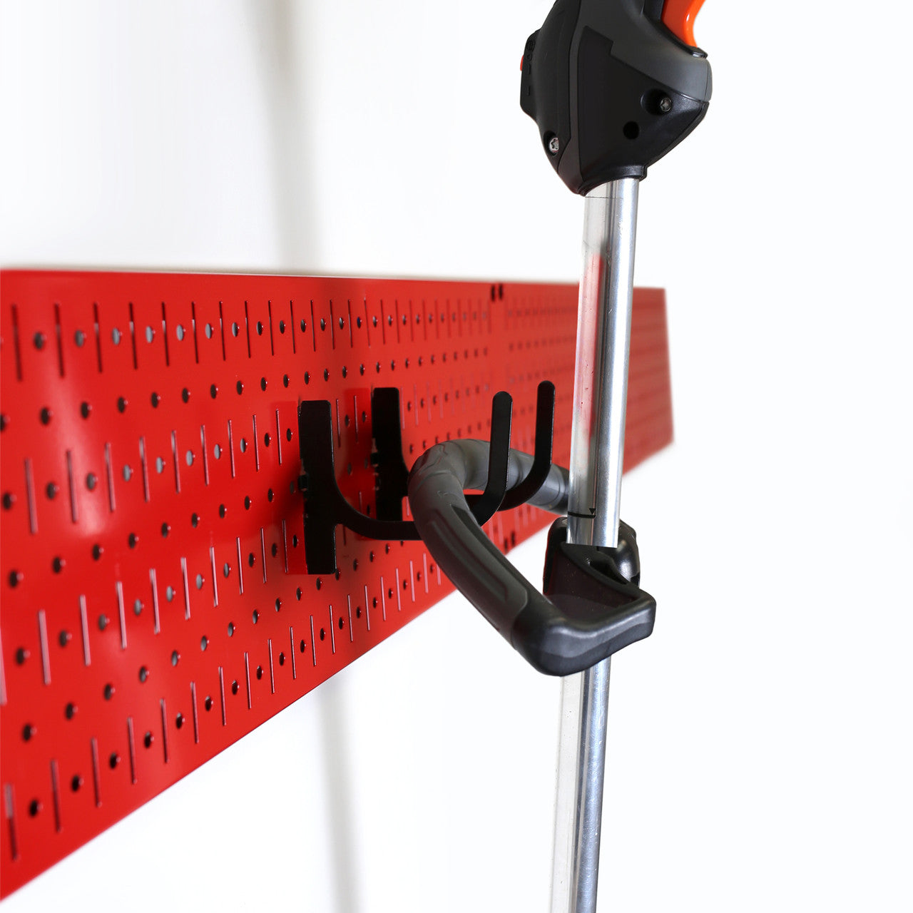 Red Metal Pegboard for Hanging Lawn Equipment