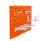 Small Orange Pegboard with White Hooks and Accessories